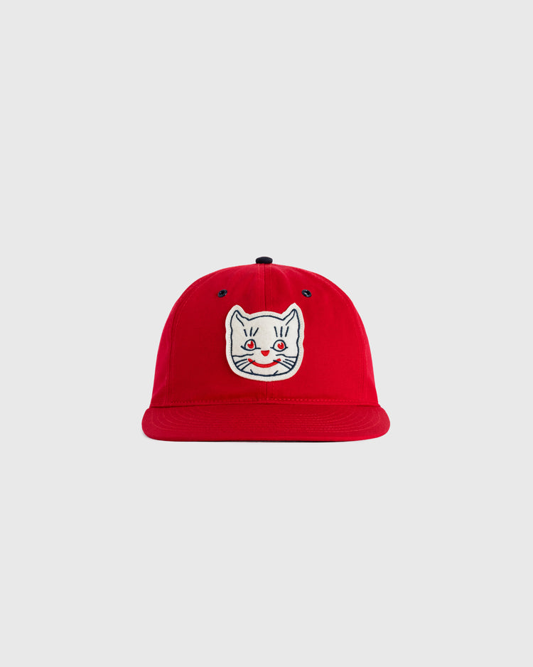 The EFF Kansas City Katz Cotton Twill Ballcap is a red hat with an embroidered white cat face, blue eyes, and a pink nose on the front, shown against a plain light gray background.