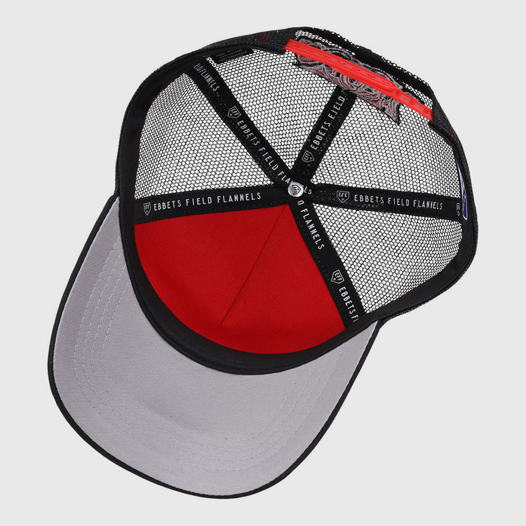 The Lake Elsinore Storm MiLB Trucker Ballcap by Ebbets Field features a red and black mesh crown, gray curved brim, black interior bands with EBBETS FIELD FLANNELS labeling, and an adjustable back strap.