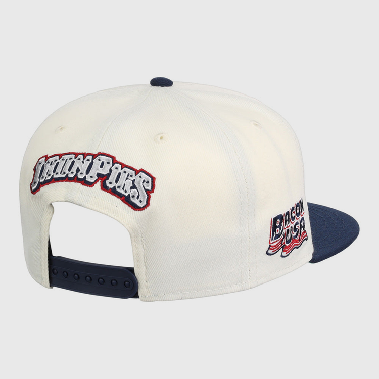 The Ebbets Field Lehigh Valley Ironpigs MiLB Snapback Ballcap is a white cap with a navy brim and adjustable strap, plus embroidered 