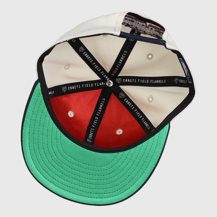 The inside of the Lehigh Valley Ironpigs MiLB Snapback Ballcap by Ebbets Field shows white and red panels, a green underbill, black taping with EBBETS FIELD FLANNELS text, and a cloth tag sewn into the sweatband.