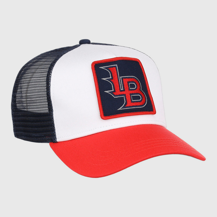 The Ebbets Field Louisville Bats MiLB Trucker Ballcap features a white front, black mesh back, red bill, and a square “LB” patch in red and white on a navy background.