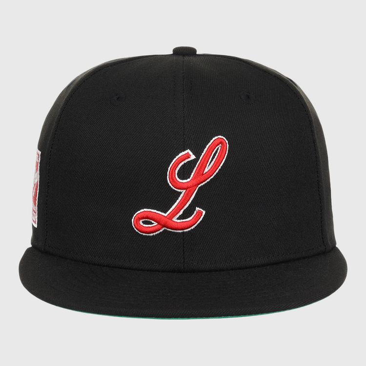 The EFF Louisville Black Caps NLB Team Color Fitted Ballcap features a black base, flat brim, red and white embroidered L on the front, and side patch honoring Negro National League heritage.