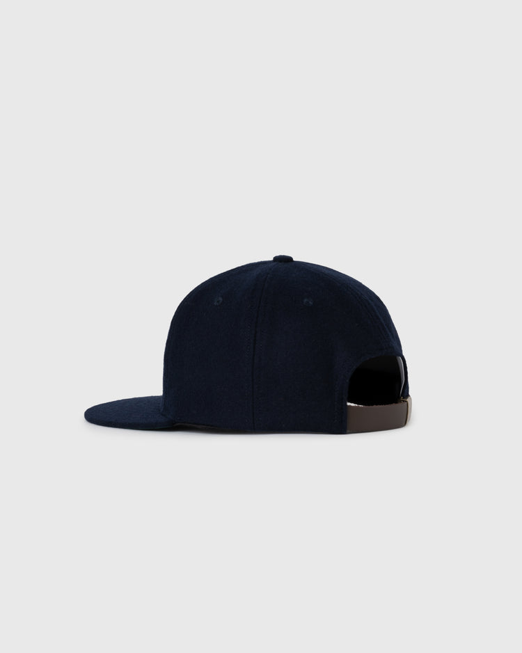 The EFF Los Angeles (PCL) 1949 Authentic Wool Ballcap, shown from the back and side on a light gray background, features navy blue vintage wool, a flat brim, and an adjustable brown strap inspired by the Pacific Coast League Angels.