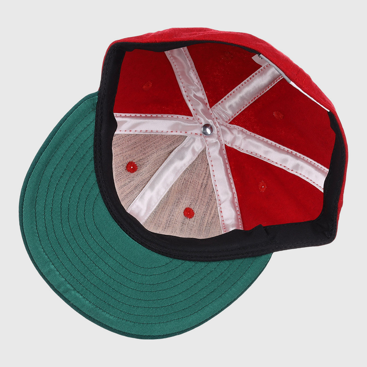 A top-down view of the EFF M&O Cigars 1946 Vintage Ballcap reveals white stitched panels, a green brim, red ventilation holes, and a silver center button.