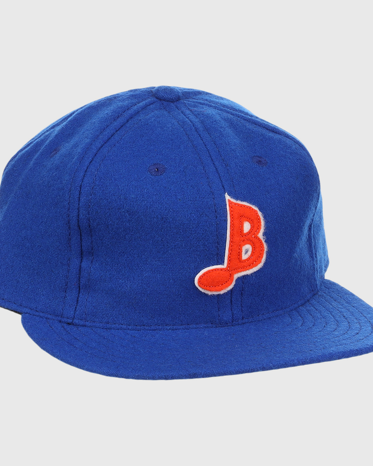 The EFF Memphis Blues Letterhead Wool Vintage Ballcap is a royal blue cap with a flat brim, featuring a red and white stylized B on the front—a classic tribute to Texas League Minor League baseball style.