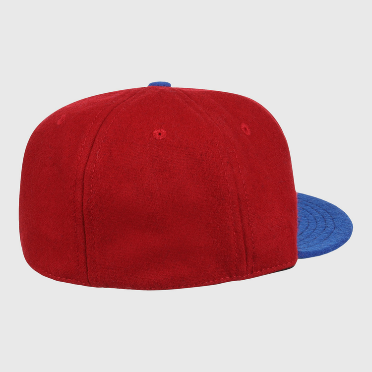 The EFF Memphis Red Sox 1946 Vintage Ballcap, a red wool cap with blue brim, is shown from back and side on a white background, echoing the classic style of the Negro American League team.