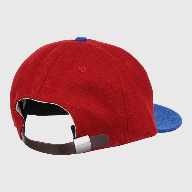 The Memphis Red Sox 1946 Vintage Ballcap by EFF features red and blue wool, a brown adjustable strap with a silver buckle, and classic details inspired by Negro American League styles.