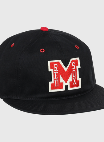 The EFF Memphis Red Sox Cotton Twill Ballcap is a black cap with a red button and eyelets, featuring a bold red M and Red Sox in white—honoring the legendary Negro American League team.