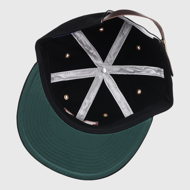 The image shows the inside of an EFF Memphis Red Sox Cotton Twill Ballcap featuring a black crown, green brim, silver lining strips, metal eyelets, and a brown adjustable strap—classic vintage details from Negro American League caps.