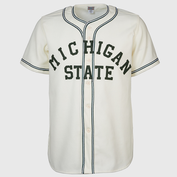 The EFF Michigan State 1940 Home Jersey is a white baseball jersey with black trim, front buttons, and MICHIGAN STATE in large dark green letters across the chest for a vintage collegiate look.