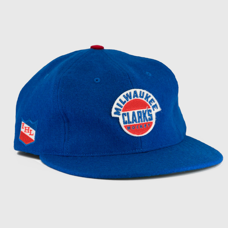 The EFF Milwaukee Clarks Vintage Ballcap is a blue wool cap with Milwaukee Clarks Hockey embroidered on the front and an IHL patch on the side—ideal for hockey fans and collectors.