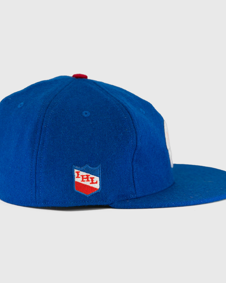 The Milwaukee Clarks Vintage Ballcap by EFF is a blue wool cap with a flat brim, featuring the International Hockey Leagues red and white shield logo on the side panel.