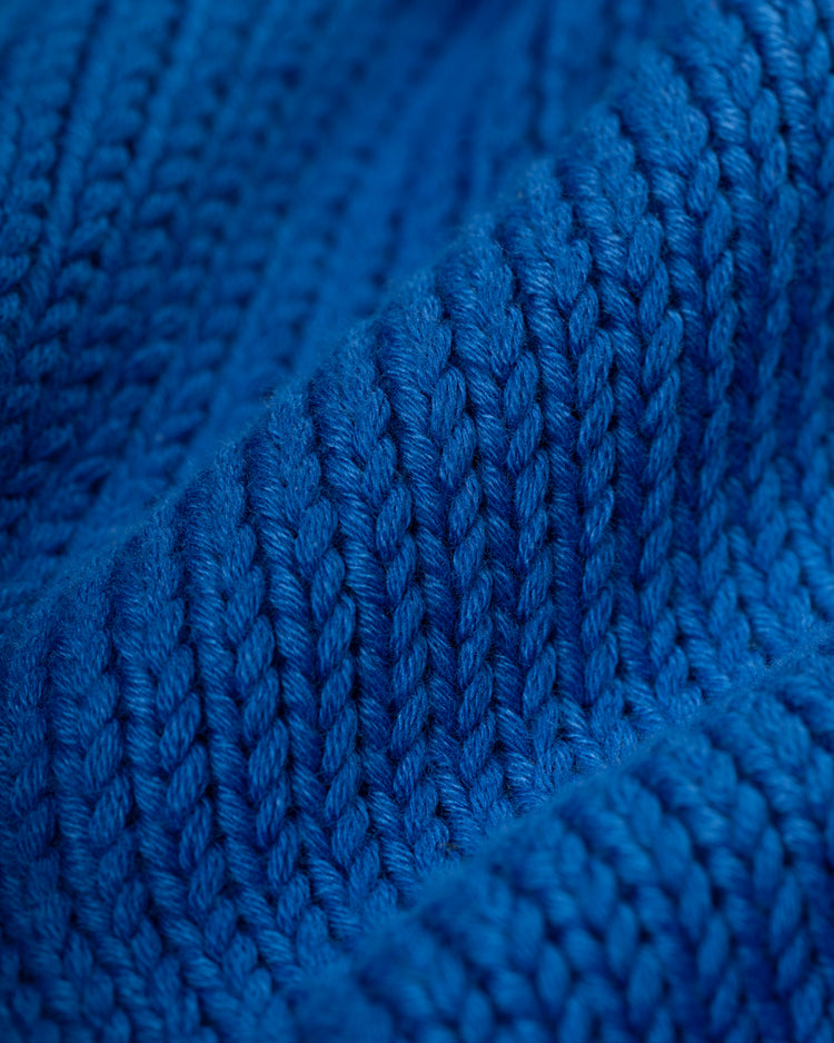 Close-up of the textured blue knit and detailed ribbing on the Kansas City Royals 1969 Wool Shawl Collar Sweater by Ebbets Field Flannels, reminiscent of vintage baseball sweaters.