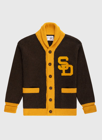 The Ebbets Field Flannels San Diego Padres 1969 Wool Shawl Collar Sweater is a brown cardigan with yellow trim, vintage-inspired details, SD initials on the left chest, and brown buttons for classic varsity style.