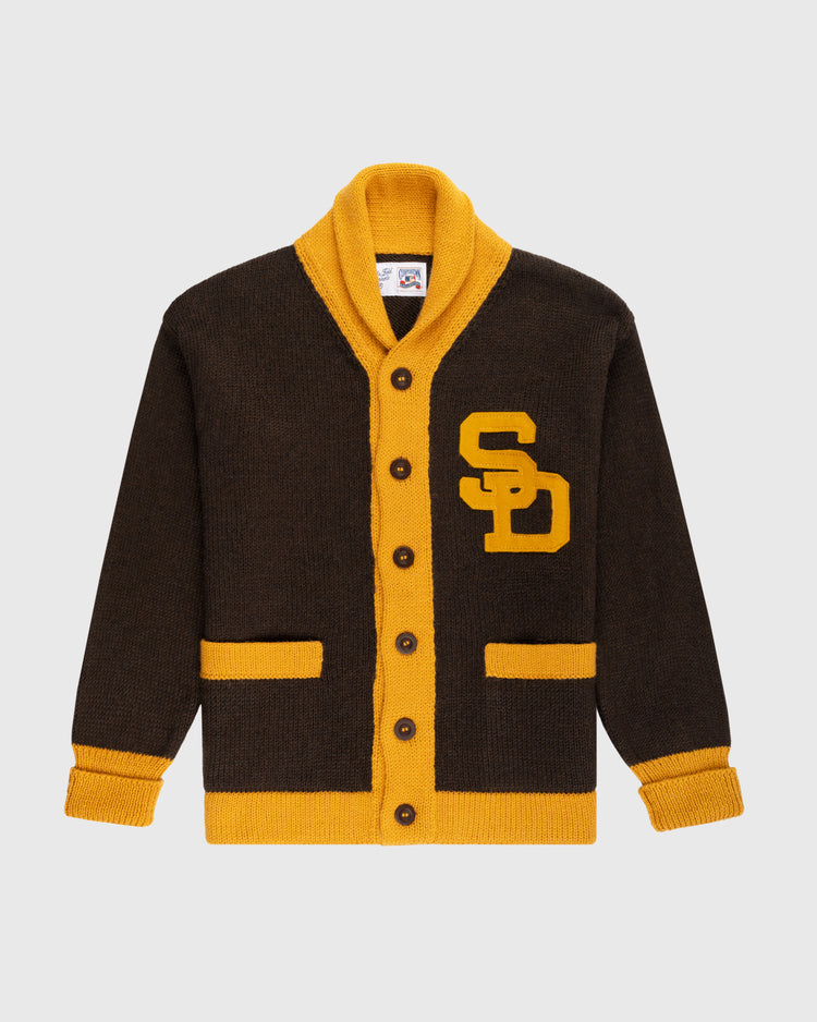 The Ebbets Field Flannels San Diego Padres 1969 Wool Shawl Collar Sweater is a brown cardigan with yellow trim, vintage-inspired details, SD initials on the left chest, and brown buttons for classic varsity style.
