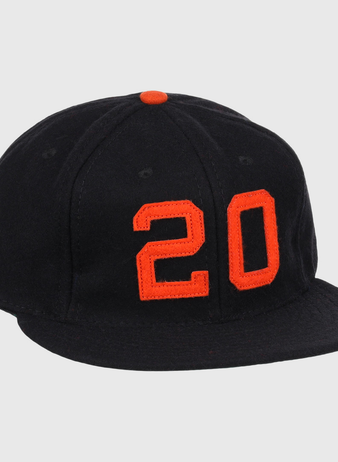 The Monte Irvin Signature Series Ballcap by Ebbets Field Flannels is a black vintage wool cap with an orange top button and bold orange number 20 on the front, honoring Monte Irvin of the Negro National League.