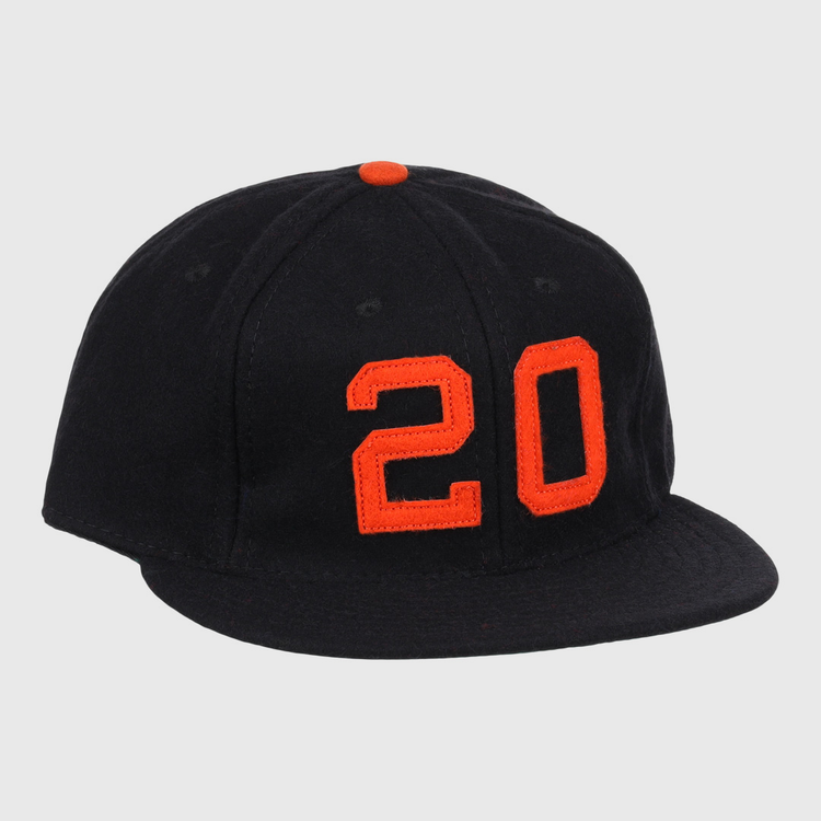 The Monte Irvin Signature Series Ballcap by Ebbets Field Flannels is a black vintage wool cap with an orange top button and bold orange number 20 on the front, honoring Monte Irvin of the Negro National League.