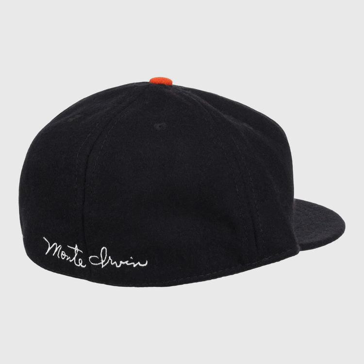 The Ebbets Field Flannels Monte Irvin Signature Series Ballcap is a vintage-style wool cap in black, featuring an orange button and white cursive Monte Irvin embroidery on the back left to honor the Negro National League legend.