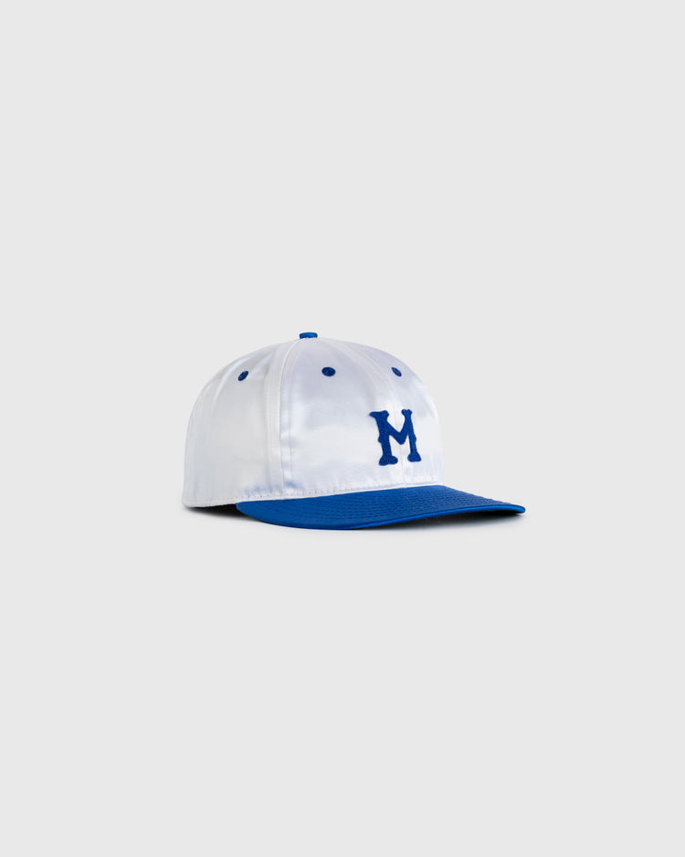 The EFF Montreal Royals 1946 Authentic All Satin Ballcap features a white crown, blue brim, top button, eyelets, and an embroidered blue M on the front, shown on a plain light gray background—a classic vintage style.