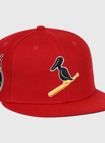 The EFF New Orleans Black Pelicans NLB Team Color Fitted Ballcap in red features a black pelican on a yellow bat, a side patch with New Orleans Black Pelicans 1922, and honors the Negro Southern League with an added small pelican graphic.
