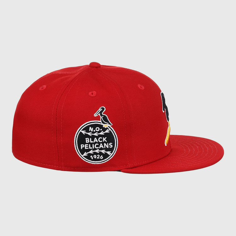 The EFF New Orleans Black Pelicans NLB Team Color Fitted Ballcap in red features embroidered patches, including a circular 1926 Negro Southern League logo with a black-and-yellow pelican on the front.