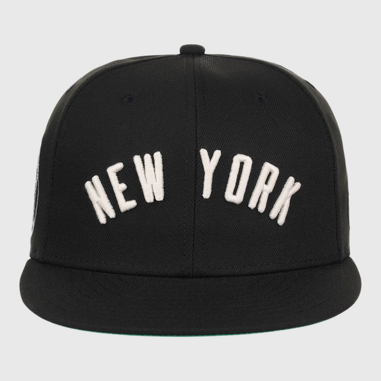 The Ebbets Field New York Black Yankees NLB Black/White Fitted Ballcap features large white 