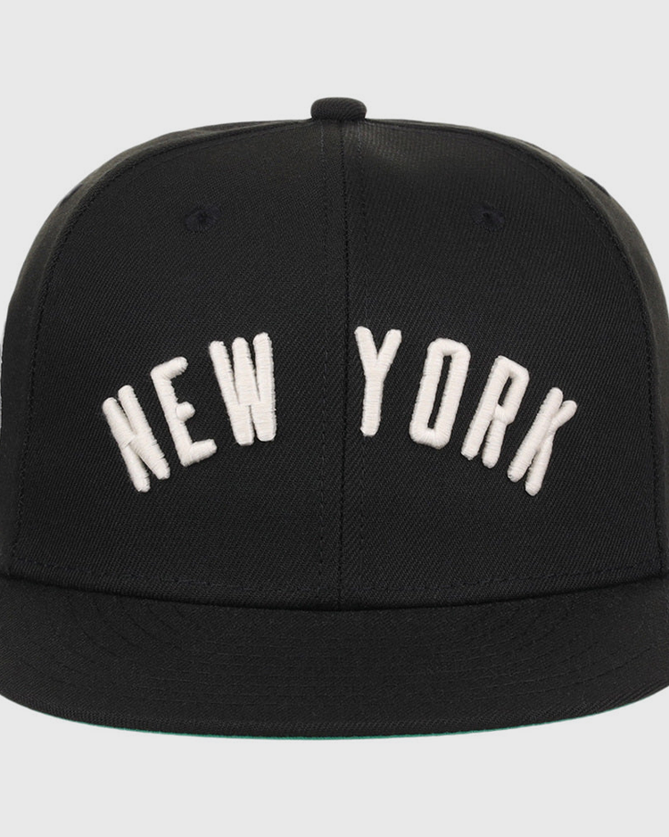 The Ebbets Field New York Black Yankees NLB Black/White Fitted Ballcap features large white 