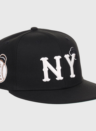 The EFF New York Black Yankees NLB Flip Fitted Ballcap features bold white NY letters, a black design, and a brown 1931 patch on the side honoring Negro National League heritage.