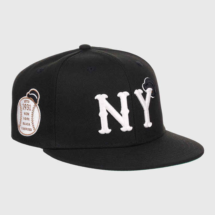 The EFF New York Black Yankees NLB Flip Fitted Ballcap features bold white NY letters, a black design, and a brown 1931 patch on the side honoring Negro National League heritage.
