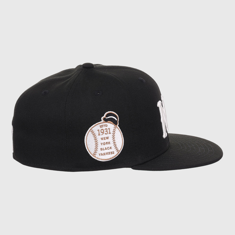 The EFF New York Black Yankees NLB Flip Fitted Ballcap is black with a white NY logo, a baseball patch reading Est. 1931, and New York Black Yankees embroidered on the side to honor the Negro National League. Flat brim design.