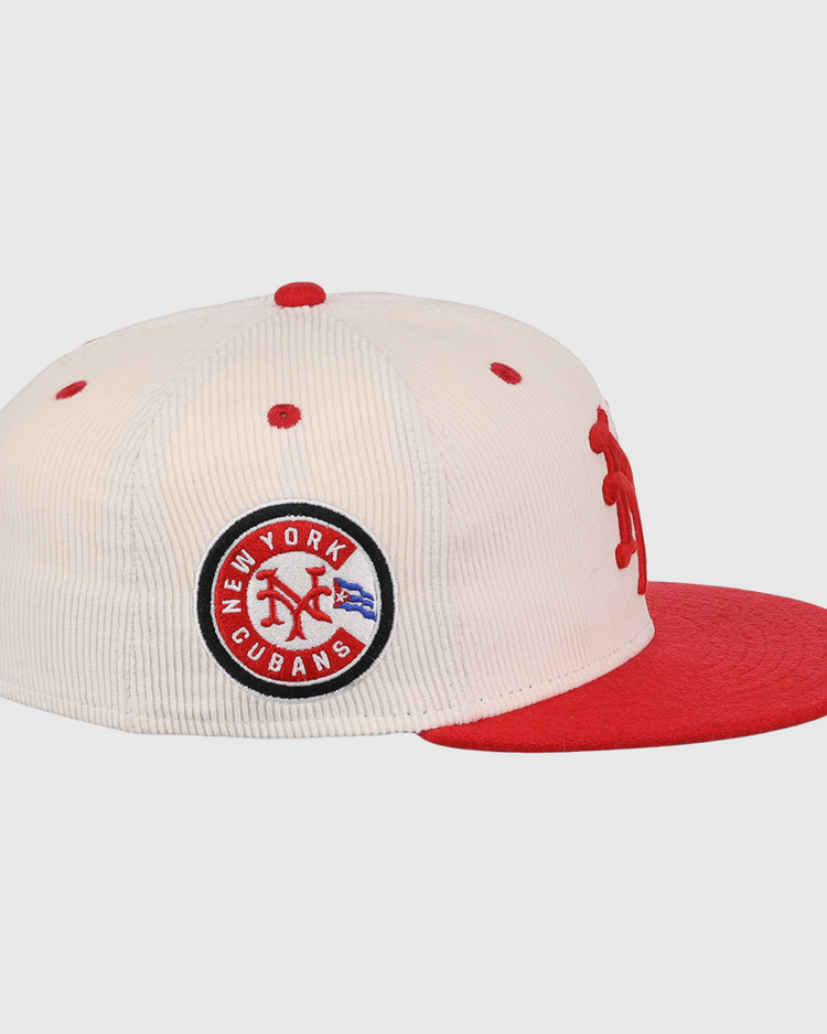 The EFF New York Cubans NLB Ground Rule Double Fitted Ballcap features cream corduroy, a red brim and button, a 3D NY logo, and a side patch reading New York Cubans in blue and red, honoring the Negro National League.