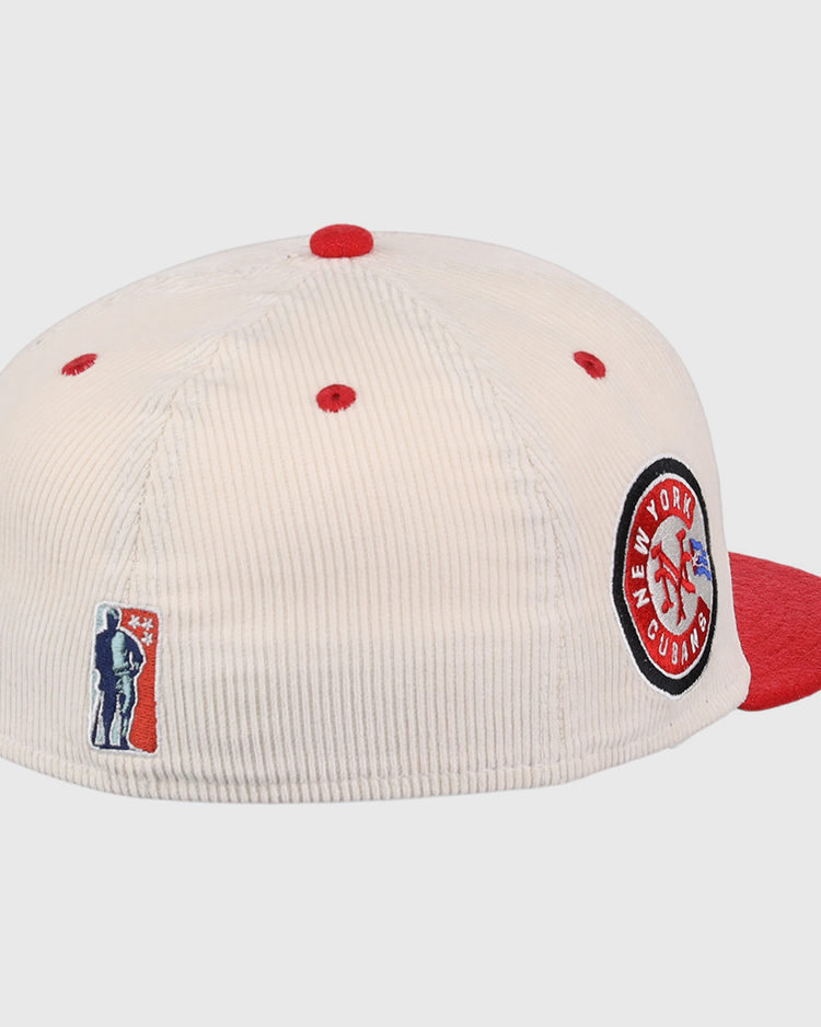 The EFF New York Cubans NLB Ground Rule Double Fitted Ballcap features a cream corduroy design with red accents and brim, a side patch honoring the Negro National League, and an embroidered baseball player logo above the back opening.