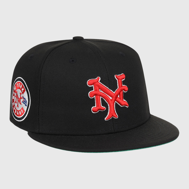 The EFF New York Cubans NLB Team Color Fitted Ballcap is a vintage-inspired black cap with a 3D red NY logo on the front and a round New York Giants patch on the side.