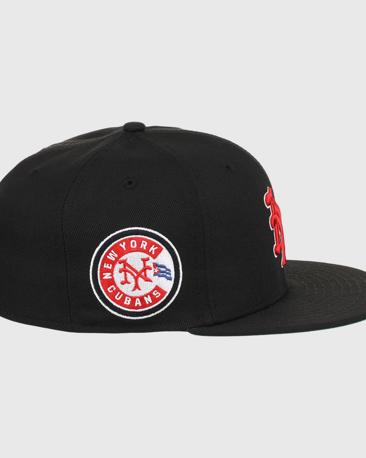 The EFF New York Cubans NLB Team Color Fitted Ballcap is a black vintage-inspired cap with a flat brim, featuring a circular patch reading New York Cubans with a red baseball logo and blue accents, honoring the Negro National League.