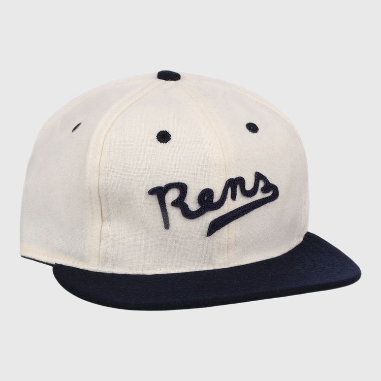 The New York Rens Wool Ballcap by Ebbets Field Flannels is a vintage-style white cap with a navy brim and Rens embroidered in script, celebrating Black basketball history and the legacy of the legendary team.