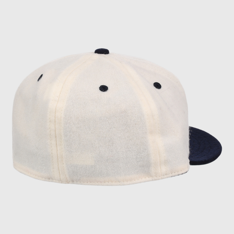 The Ebbets Field Flannels New York Rens Wool Ballcap features a dark navy brim, white panels with black stitching, vintage-inspired seams, and a round top button, shown from the back.