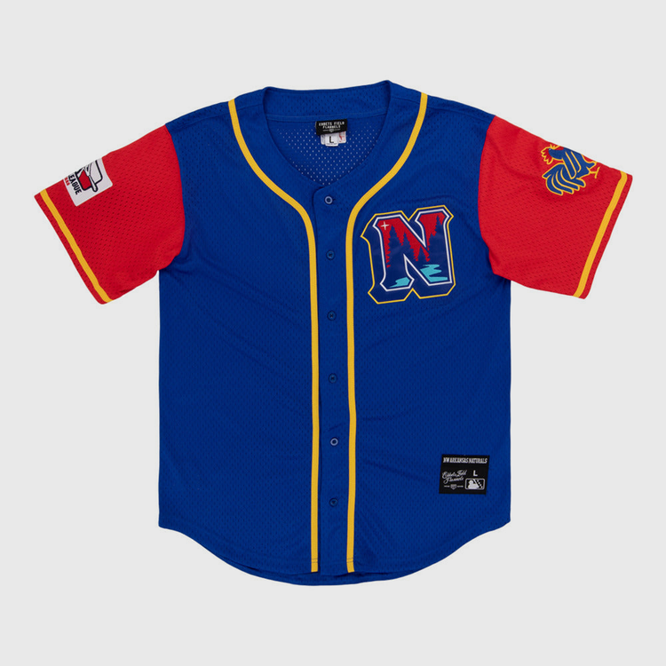 The Ebbets Field Northwest Arkansas Naturals MiLB Button Down Jersey features blue fabric, yellow trim, red sleeves, a left-sleeve patch, lion logo on the right sleeve, and a chest 