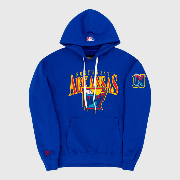 The Ebbets Field Northwest Arkansas Naturals MiLB Cotton Hooded Sweatshirt is royal blue with an Arkansas outline and claw marks on the front, a stylized N logo, an embroidered N patch on the left sleeve, and a red logo on the right cuff.