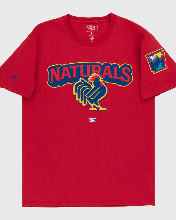 The Ebbets Field Northwest Arkansas Naturals MiLB Fashion Cotton Short Sleeve Tee is a red shirt with a large stylized rooster graphic and 