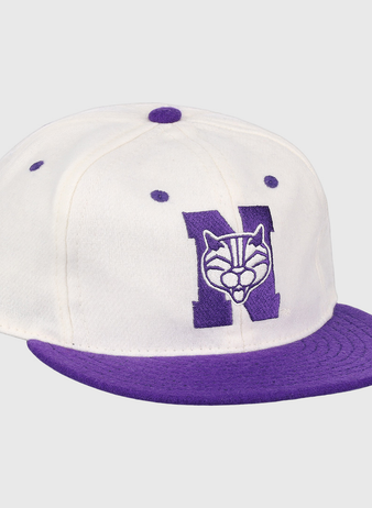 The EFF Northwestern University Vintage Ballcap is a white cap with a purple brim and button, featuring a large purple N with wildcat face embroidery—a classic vintage college baseball hat.
