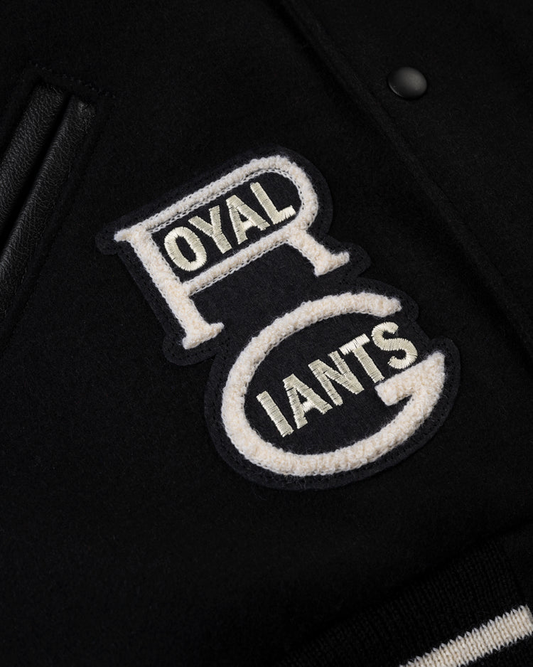 Close-up of the Ebbets Field Negro League Wool & Leather Varsity Jacket, featuring a bold ROYAL GIANTS patch and textured fabric that honors historic teams such as the New York Black Yankees.
