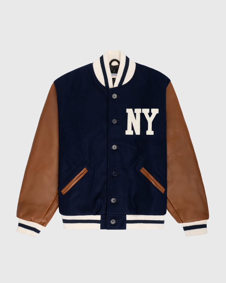 The EFF New York Black Yankees 1940 Authentic Wool & Leather Varsity Jacket features a navy wool body, brown leather sleeves, white striped cuffs and collar, plus bold NY chest letters—crafted in partnership with the Negro Leagues Baseball Museum.