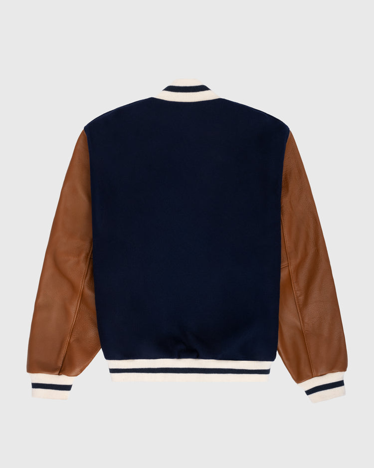 The EFF New York Black Yankees 1940 Authentic Wool & Leather Varsity Jacket features a navy body, brown leather sleeves, and white ribbed trim with black stripes on the cuffs, collar, and hem, shown from the back on a plain light background.