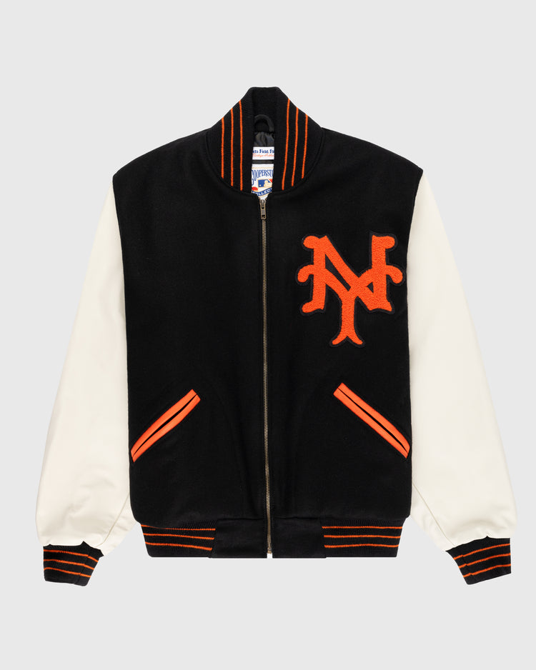 The EFF New York Giants 1951 Authentic Wool & Leather Varsity Jacket features black Pendleton wool, white leather sleeves, orange and black striped cuffs and collar, an orange NY logo on the chest, orange-trimmed pockets, and a front zipper.