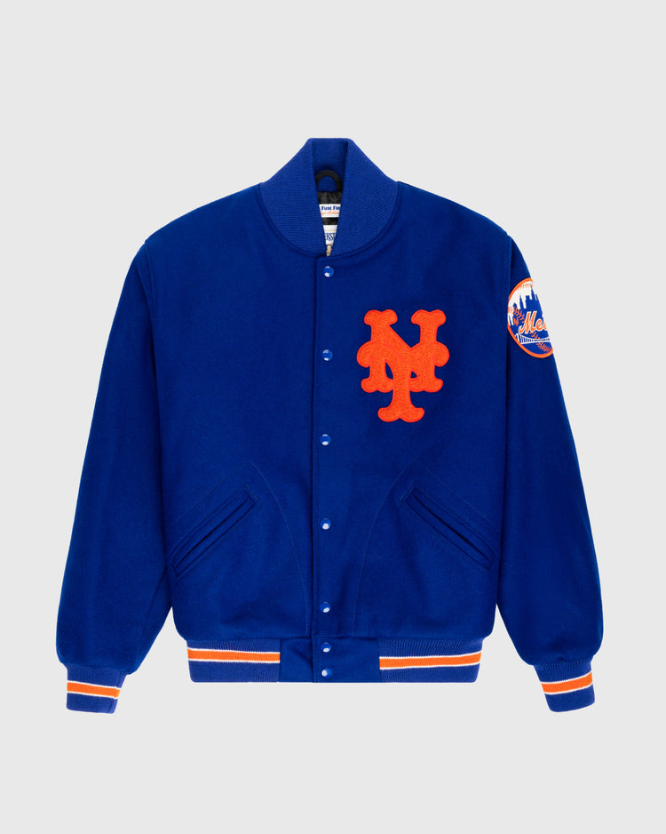 The EFF New York Mets 1969 Authentic All Wool Varsity Jacket in royal blue features orange and white striped cuffs and hem, a large orange NY logo on the chest, and a 1969 World Series team patch on the left sleeve.