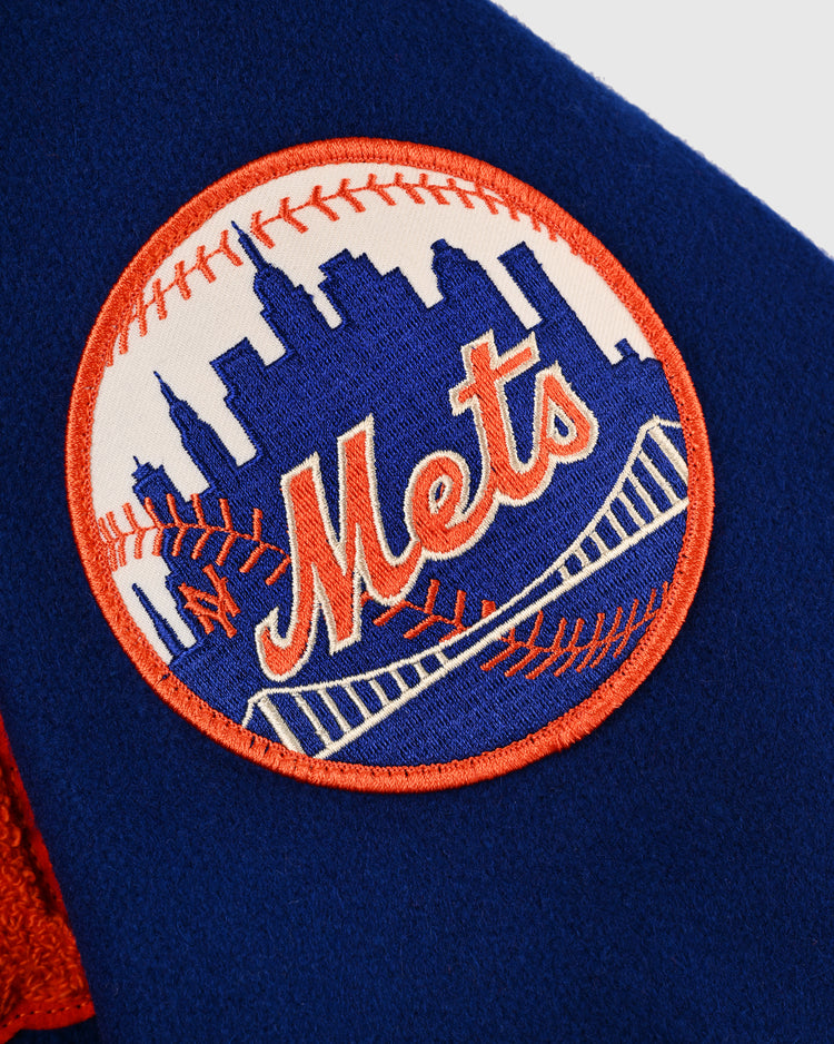 Close-up of the New York Mets logo patch on the EFF New York Mets 1969 Authentic All Wool Varsity Jacket, featuring an orange baseball, blue city skyline, and Mets script—ideal for any World Series fan.