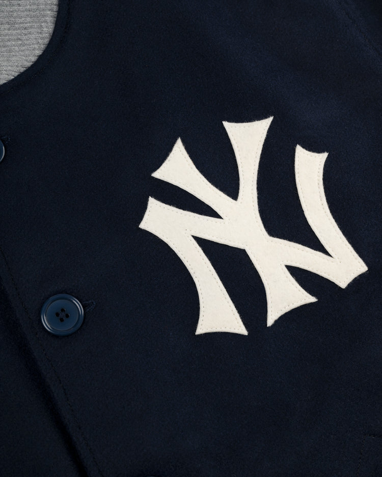 Close-up of the EFF New York Yankees 1936 Authentic All Wool Varsity Jacket, showing a large white Yankees logo on the chest and a prominent dark blue button.