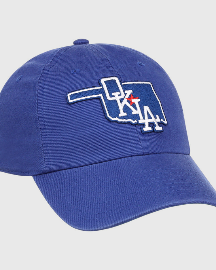 The Ebbets Field Oklahoma City Dodgers MiLB Dad Ballcap is a blue cap featuring an outline of Oklahoma with 