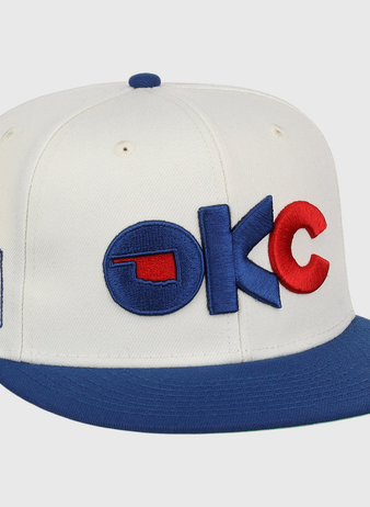 The Oklahoma City Dodgers MiLB Snapback Ballcap by Ebbets Field is a white cap with a blue brim, 