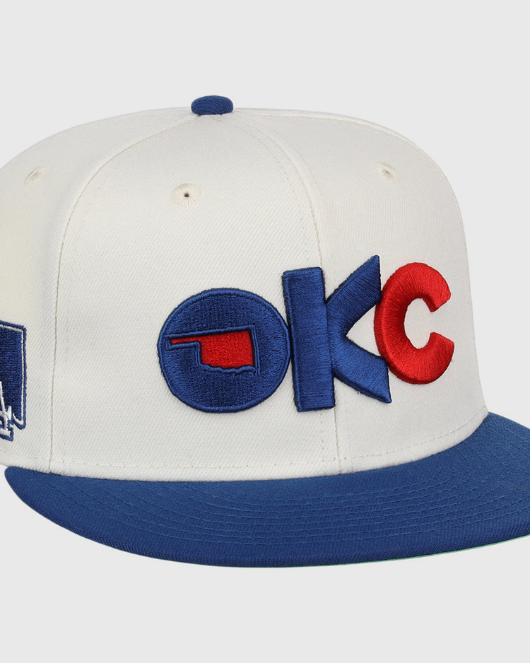 The Oklahoma City Dodgers MiLB Snapback Ballcap by Ebbets Field is a white cap with a blue brim, 